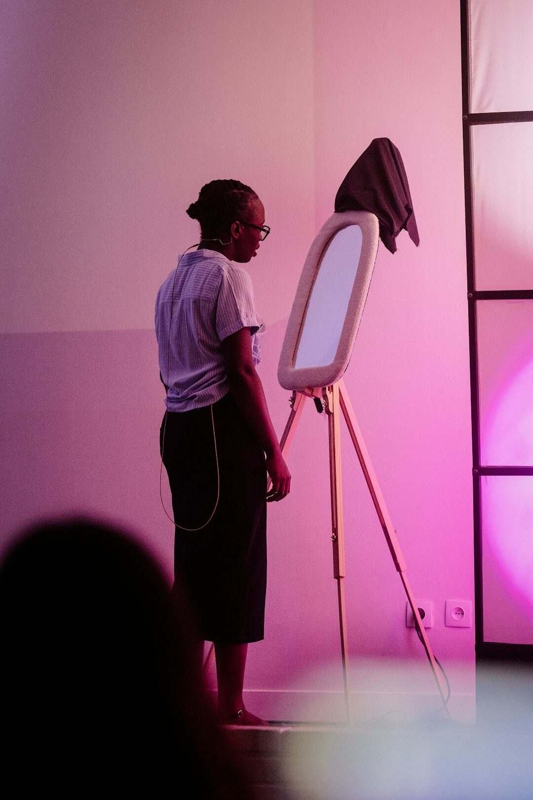 Woman practicing a confident presentation in a bright workshop room