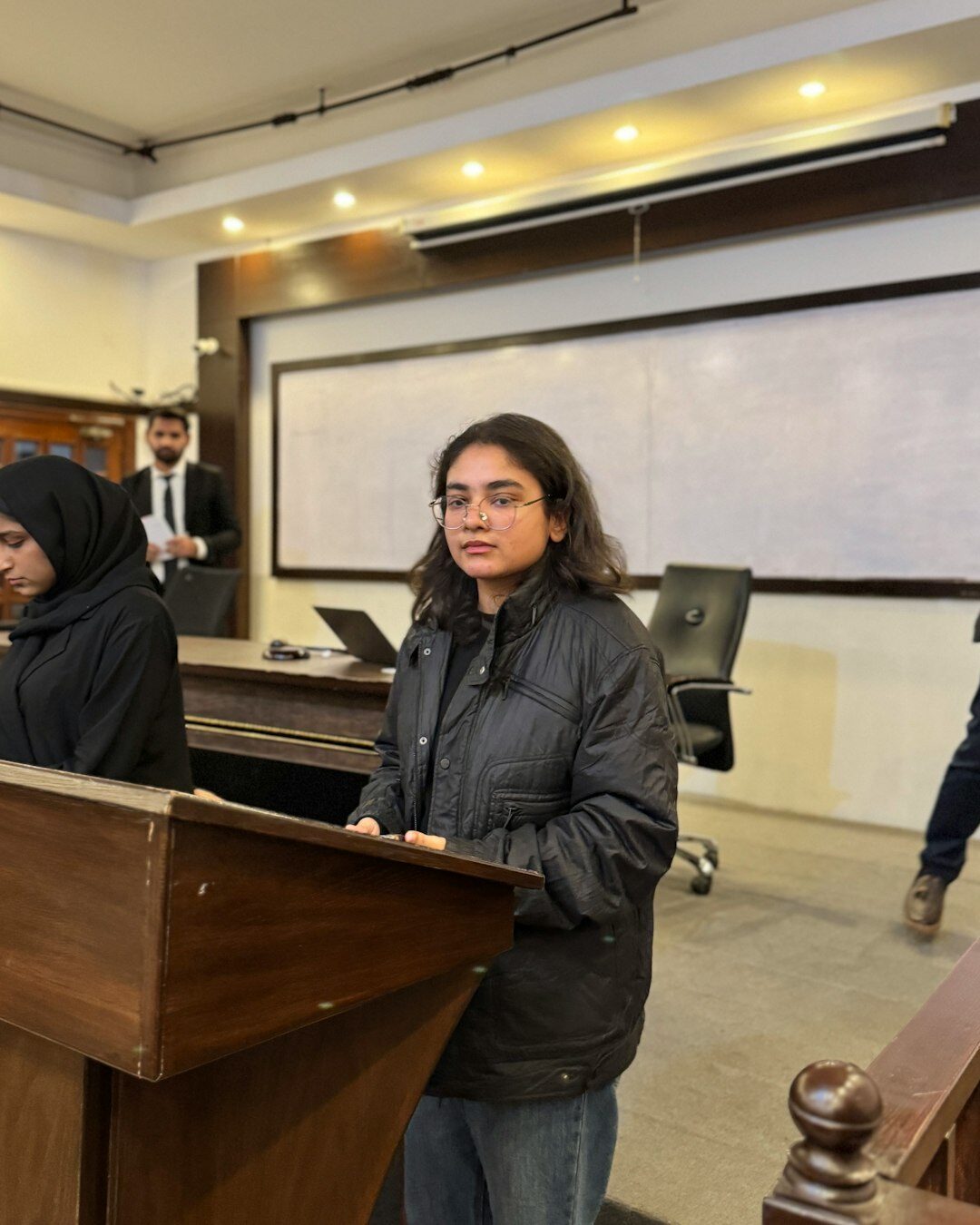 confident woman speaking at podium